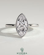 Kynora CJ 2ct marquise bezel solitaire engagement ring with petal gallery design showcasing a sparkling marquise-cut diamond.