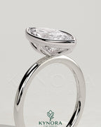 Kynora CJ 2ct marquise bezel solitaire engagement ring with petal gallery design in gold, showcasing the detailed setting and sparkling stone.