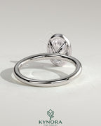Kynora CJ 2ct oval bezel solitaire engagement ring featuring a central oval diamond set in a sleek bezel setting.