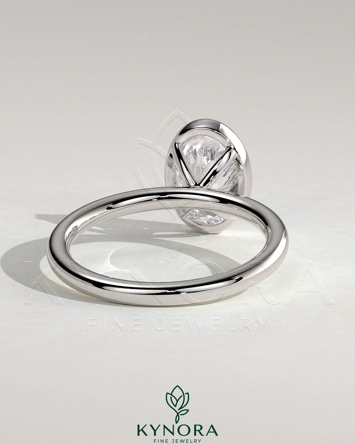 Kynora CJ 2ct oval bezel solitaire engagement ring featuring a central oval diamond set in a sleek bezel setting.