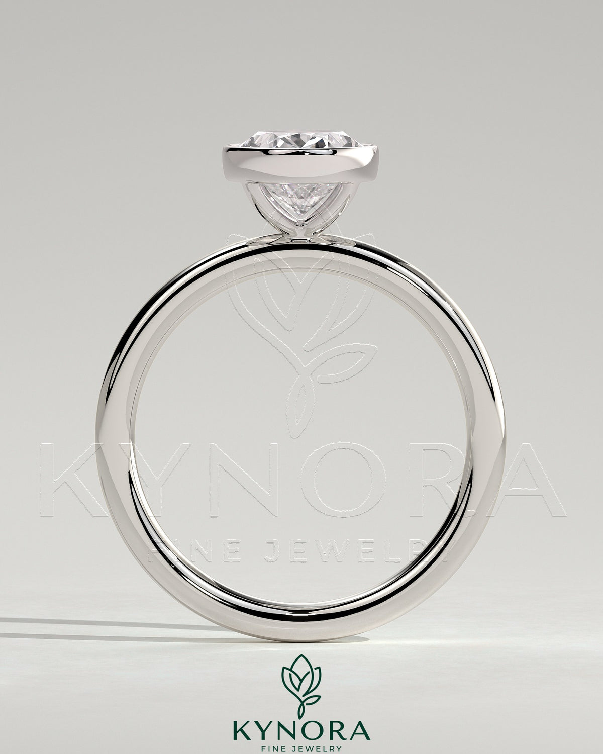 Kynora CJ 2ct oval bezel solitaire engagement ring featuring a central oval diamond set in a sleek bezel setting.