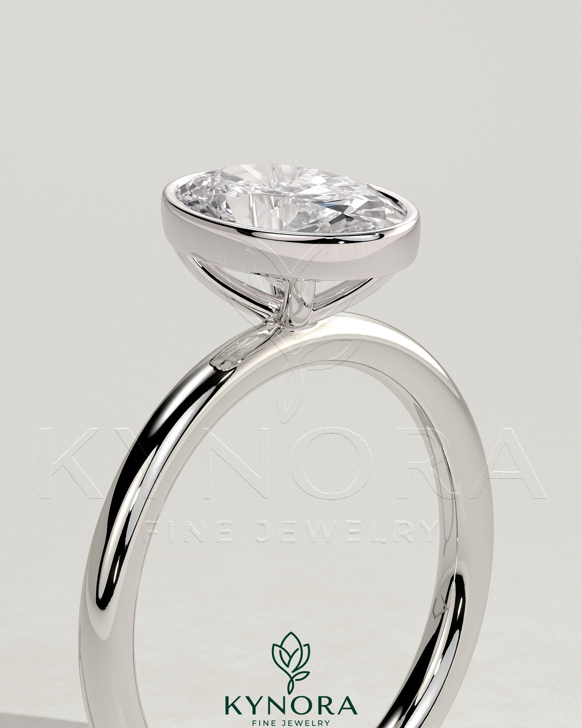 Elegant 2ct oval bezel solitaire engagement ring by Kynora CJ featuring a central oval diamond set in a sleek bezel setting.