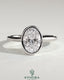 Kynora CJ 2ct oval bezel solitaire engagement ring with cathedral high setting, showcasing a sparkling oval diamond and elegant band.