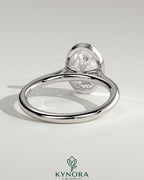 Kynora CJ 2ct oval bezel solitaire engagement ring with cathedral high setting and elegant design.