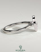 Kynora CJ 2ct oval bezel solitaire engagement ring with cathedral high setting, showcasing a sparkling oval diamond and elegant band.