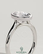 Kynora CJ 2ct oval bezel solitaire engagement ring with cathedral high setting, featuring a prominent oval diamond and intricate band design.