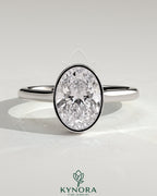 Kynora CJ 2ct oval bezel solitaire engagement ring with hidden halo and cathedral high setting, showcasing sparkling diamond and detailed design.