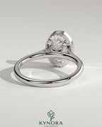 Kynora CJ 2ct oval bezel solitaire engagement ring with hidden halo and cathedral high setting, showcasing elegant diamond details.