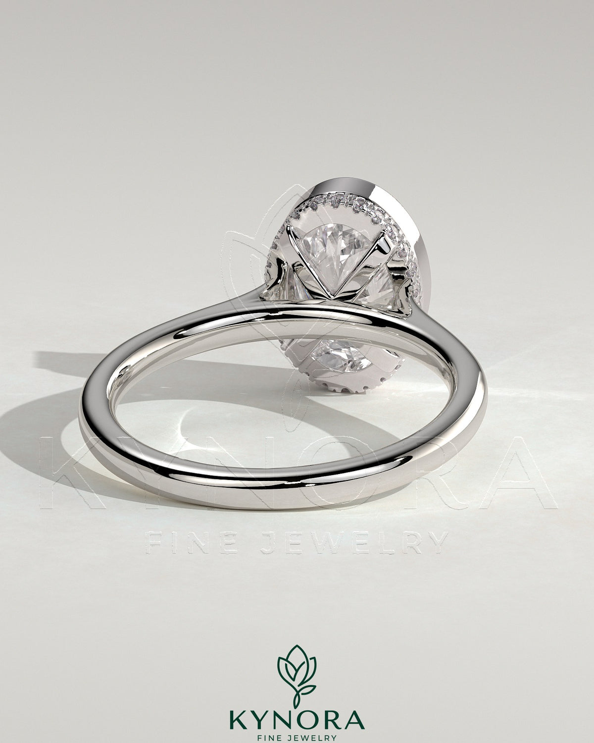 Kynora CJ 2ct oval bezel solitaire engagement ring with hidden halo and cathedral high setting, showcasing elegant diamond details.