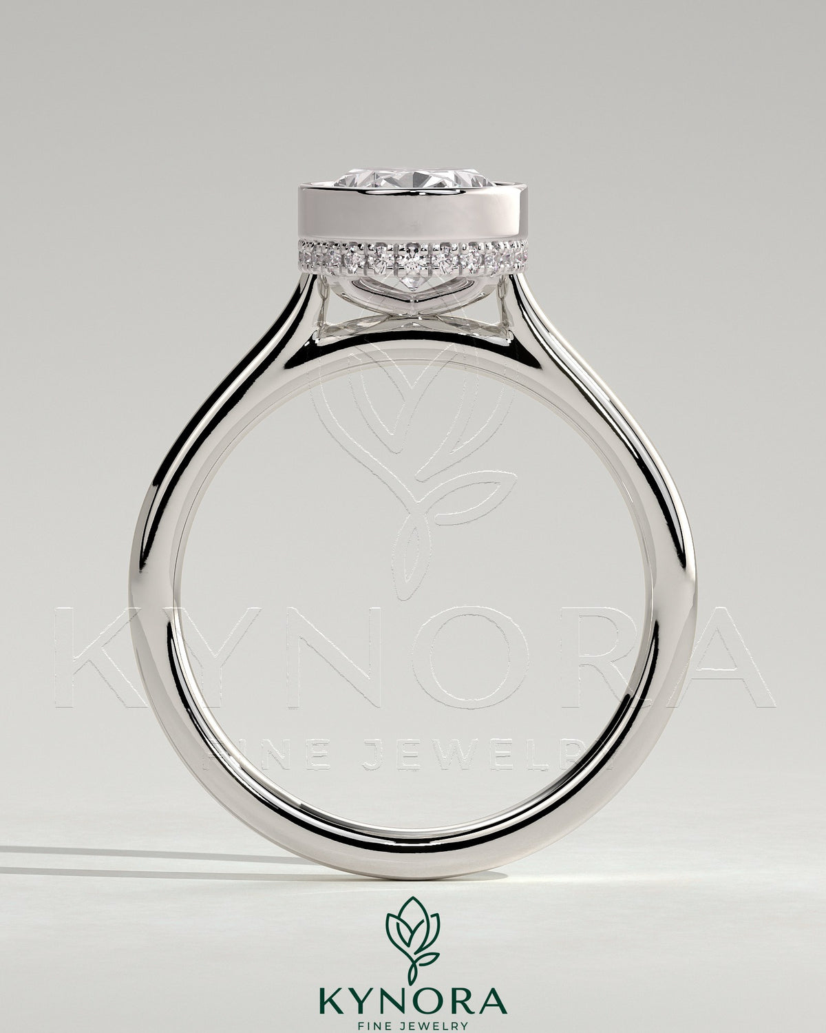 Kynora CJ 2ct oval bezel solitaire engagement ring with hidden halo and cathedral high setting, showcasing intricate metalwork.