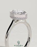 Kynora CJ 2ct oval bezel solitaire engagement ring with hidden halo and cathedral high setting in platinum.