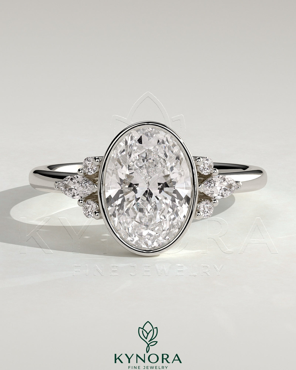Kynora CJ 2ct oval bezel solitaire engagement ring with marquise and round shoulder stones in a cathedral high setting.