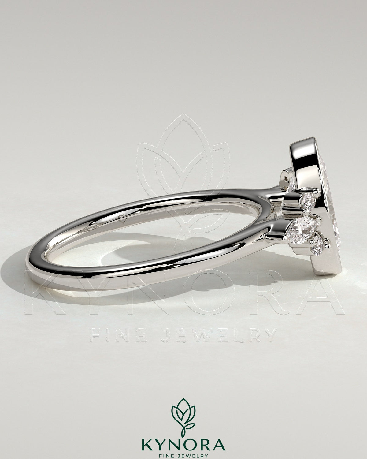 Kynora CJ 2ct oval bezel solitaire engagement ring with marquise and round shoulder stones in a cathedral high setting.