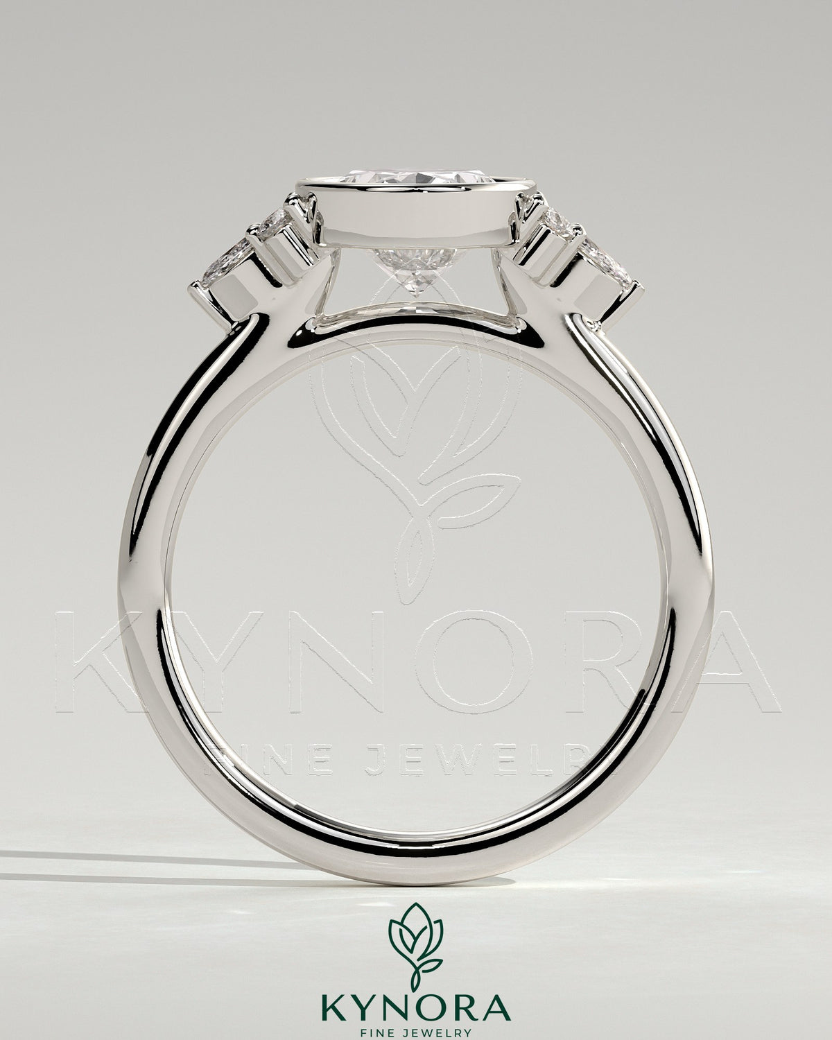Kynora CJ 2ct oval bezel solitaire engagement ring with marquise and round shoulder stones in a cathedral high setting.
