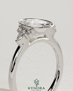 Kynora CJ 2ct oval bezel solitaire engagement ring with marquise and round shoulder stones in a cathedral high setting.