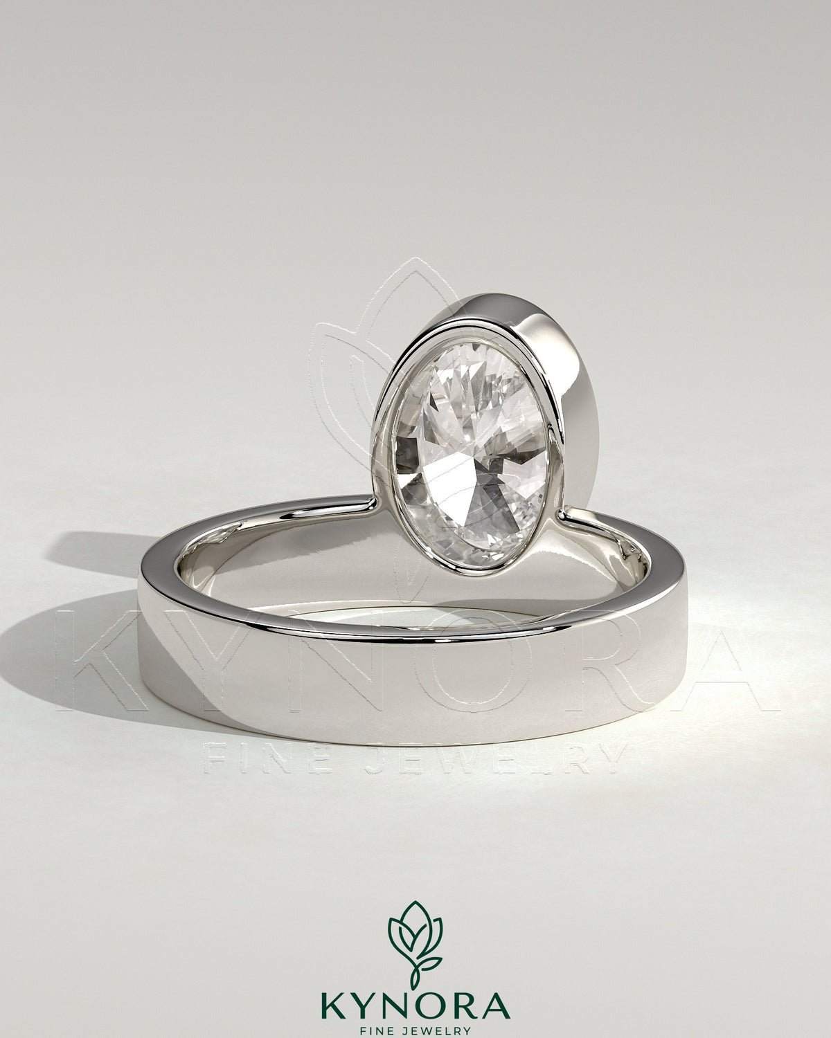 Kynora CJ 2ct oval bezel solitaire engagement ring with offset setting and flat cigar band in sterling silver or gold.