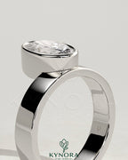Kynora CJ 2ct oval bezel solitaire engagement ring with offset setting and flat cigar band in gold, showcasing elegant jewelry design