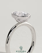 Kynora CJ 2ct oval bezel solitaire engagement ring with petal gallery design in silver with a prominent oval diamond.
