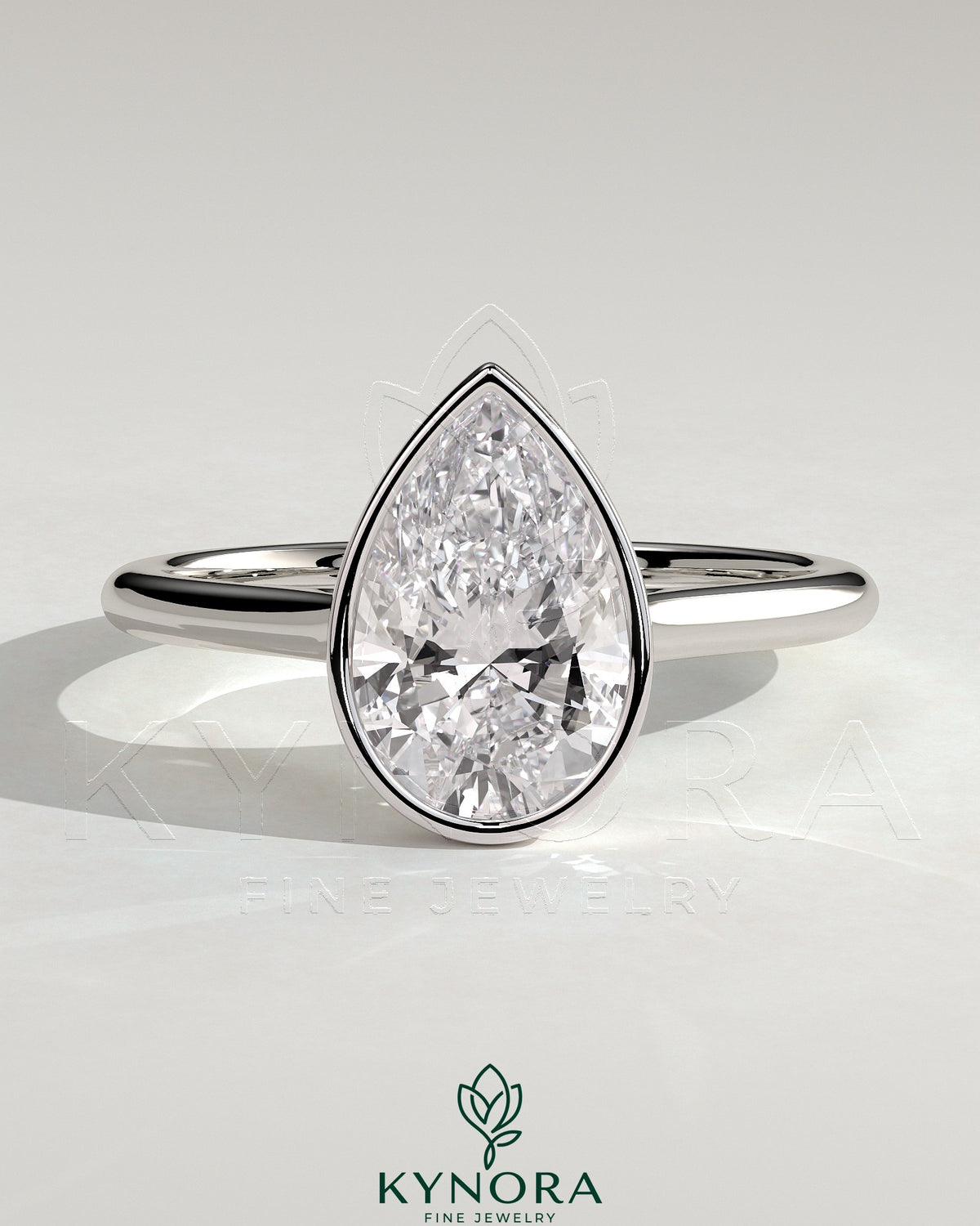 Kynora CJ 2ct pear-shaped diamond bezel solitaire engagement ring with cathedral high setting and intricate metalwork. Main image
