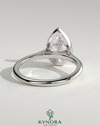 Kynora CJ 2ct pear-shaped diamond bezel solitaire engagement ring with cathedral high setting, showcasing elegant jewelry design.