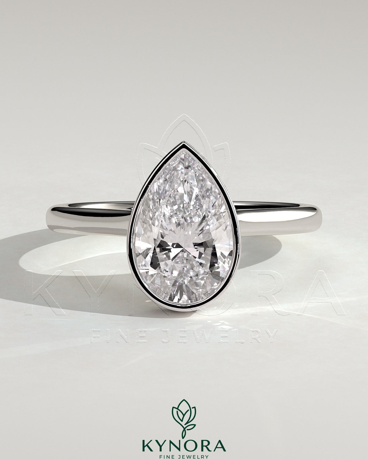 Kynora CJ 2ct pear-shaped bezel solitaire engagement ring with hidden halo and cathedral high setting, showcasing elegant diamond design. Main image