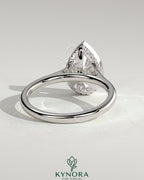Kynora CJ 2ct pear-shaped diamond bezel solitaire engagement ring with hidden halo and cathedral high setting, showcasing elegant craftsmanship.