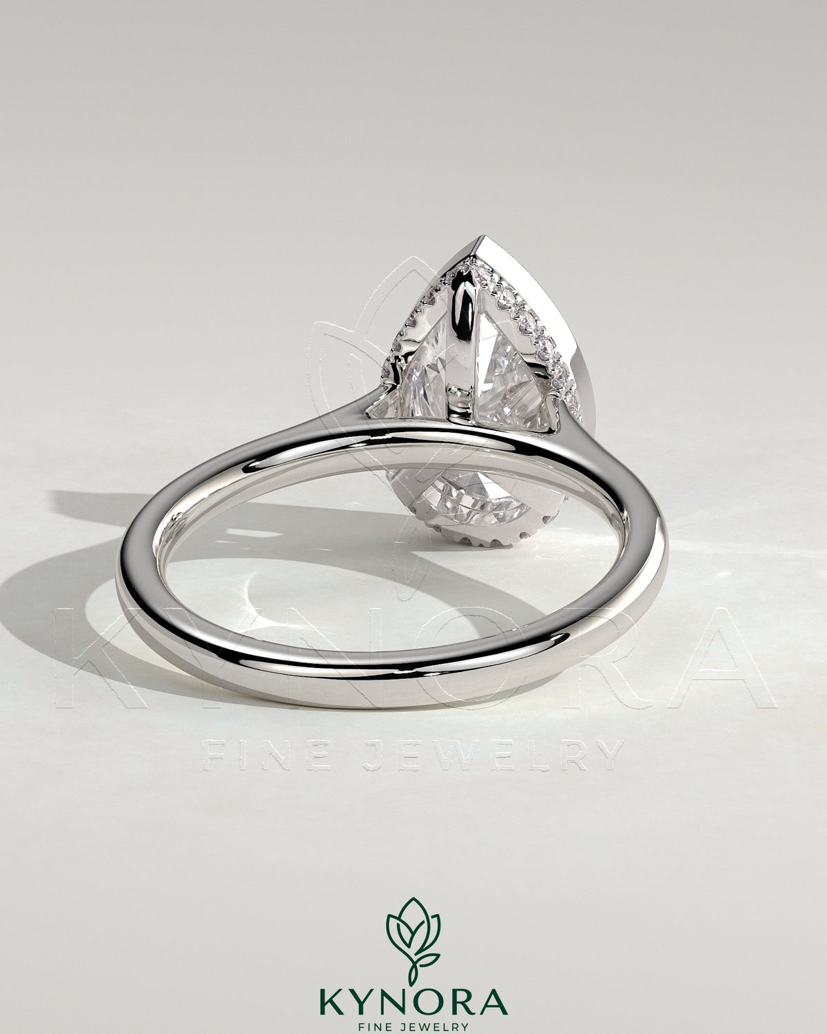Kynora CJ 2ct pear-shaped diamond bezel solitaire engagement ring with hidden halo and cathedral high setting, showcasing elegant craftsmanship.