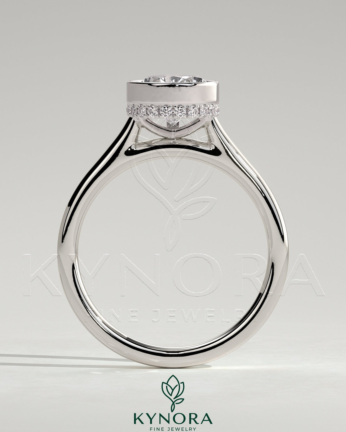 Kynora CJ 2ct pear-shaped bezel solitaire engagement ring with hidden halo and cathedral high setting, showcasing fine jewelry craftsmanship.