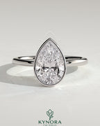Kynora CJ 2ct pear-shaped diamond bezel solitaire engagement ring with petal gallery design, showcasing elegant craftsmanship.