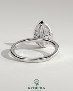Kynora CJ 2ct pear-shaped bezel solitaire engagement ring with petal gallery design in sterling silver.