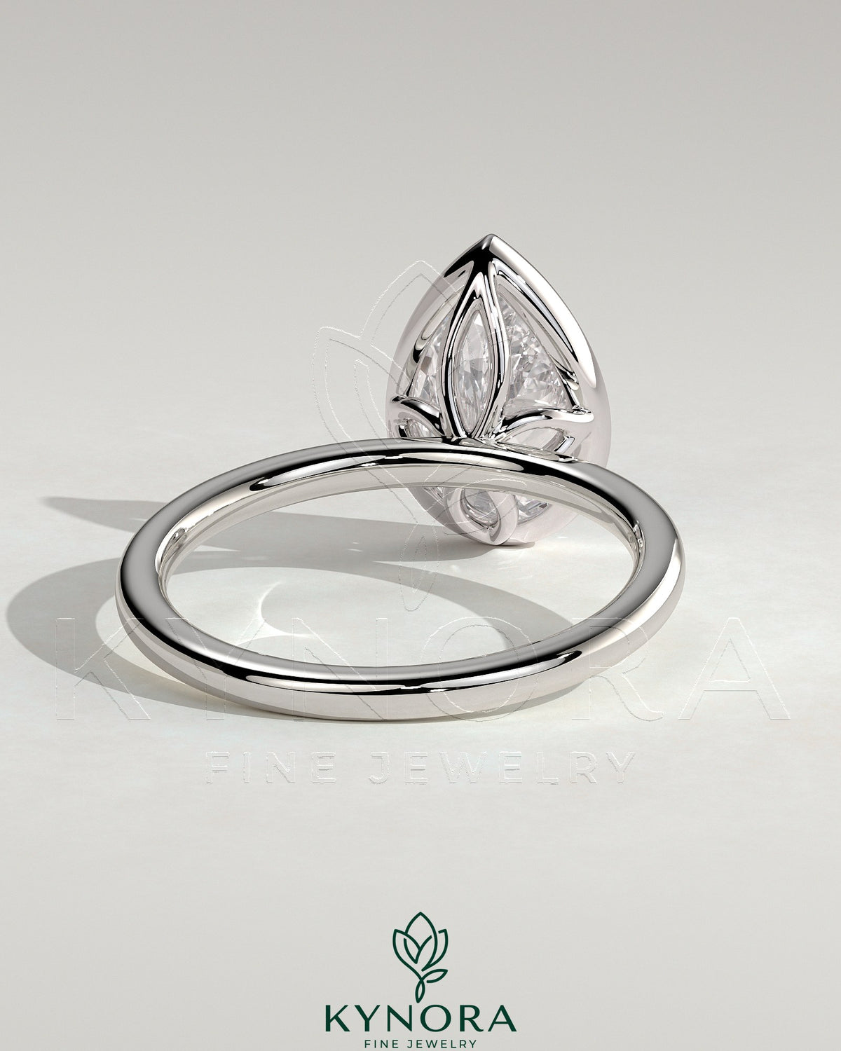 Kynora CJ 2ct pear-shaped bezel solitaire engagement ring with petal gallery design in sterling silver.