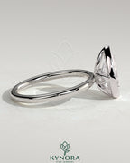 Kynora CJ 2ct pear-shaped diamond bezel solitaire engagement ring with petal gallery design and intricate band details.