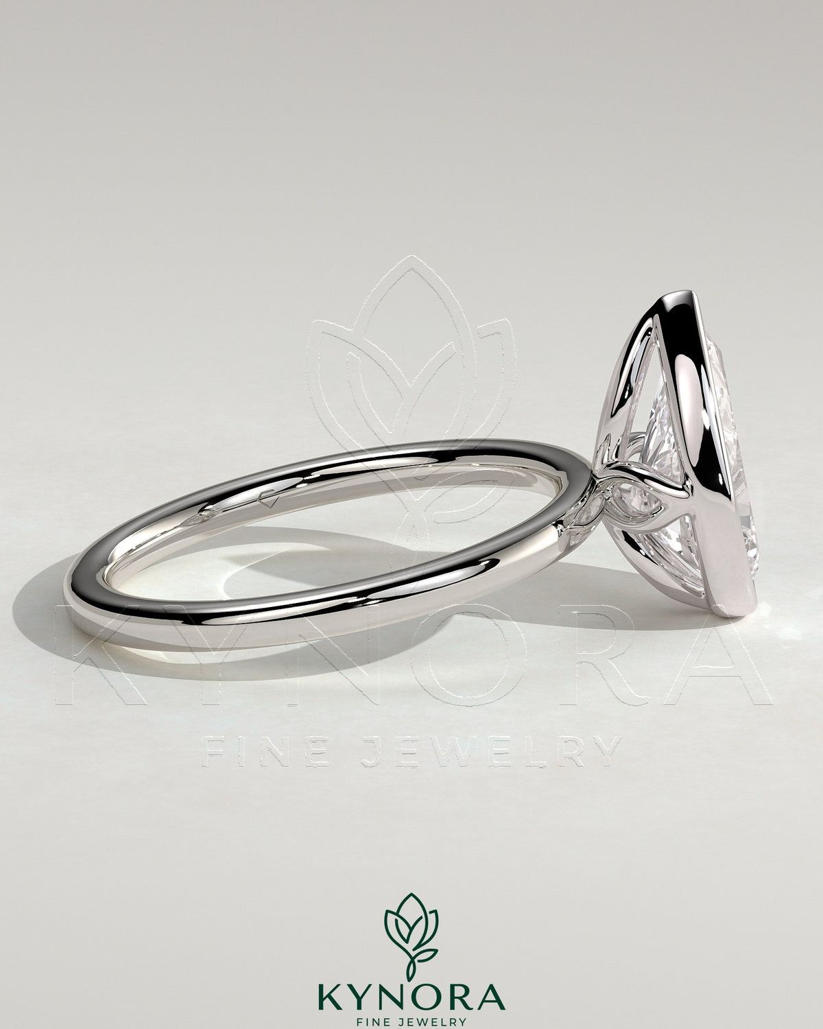 Kynora CJ 2ct pear-shaped diamond bezel solitaire engagement ring with petal gallery design and intricate band details.