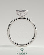 Kynora CJ 2ct pear-shaped diamond bezel solitaire engagement ring with petal gallery design, showcasing diamond and intricate band details.