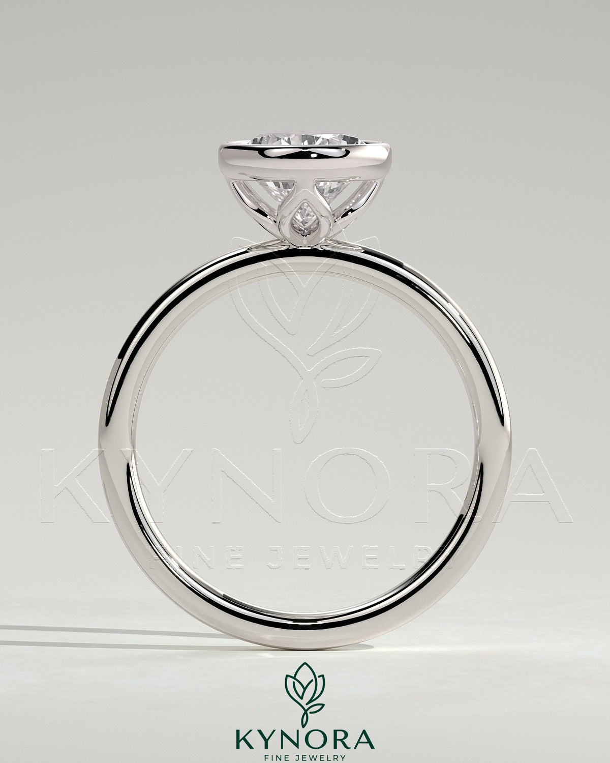 Kynora CJ 2ct pear-shaped diamond bezel solitaire engagement ring with petal gallery design, showcasing diamond and intricate band details.