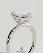 Kynora CJ 2ct pear-shaped diamond bezel solitaire engagement ring with petal gallery design, showcasing intricate craftsmanship.