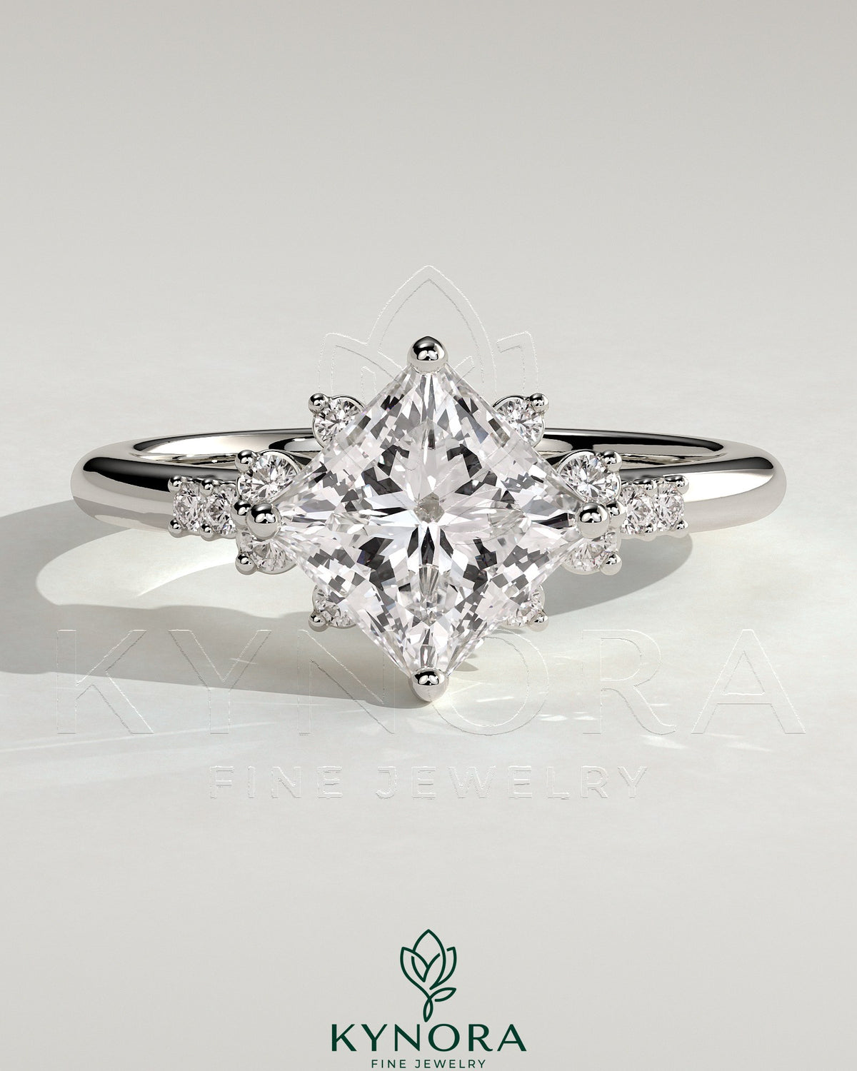 Bezel engagement ring by Kynora CJ featuring a 2ct princess claw solitaire with angled setting and clustered round shoulder stones. Main image