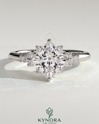 Bezel engagement ring by Kynora CJ featuring a 2ct princess claw solitaire with angled setting and clustered round shoulder stones.
