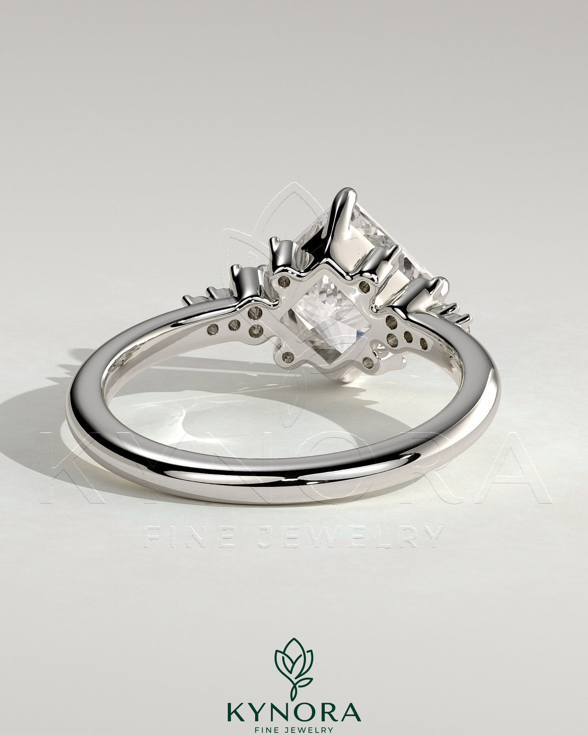 Kynora CJ 2ct princess cut solitaire engagement ring with angled bezel setting and clustered round shoulder stones.