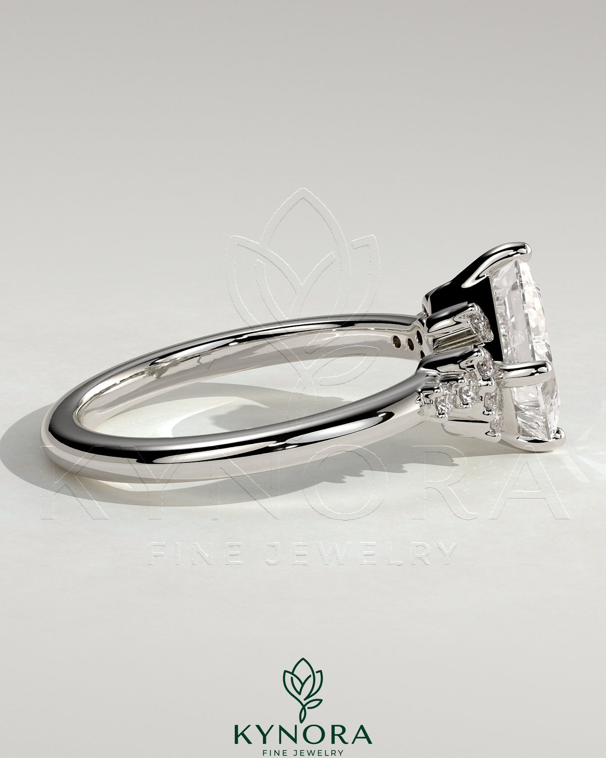 Kynora CJ 2ct princess claw solitaire engagement ring with angled bezel setting and clustered round shoulder stones.