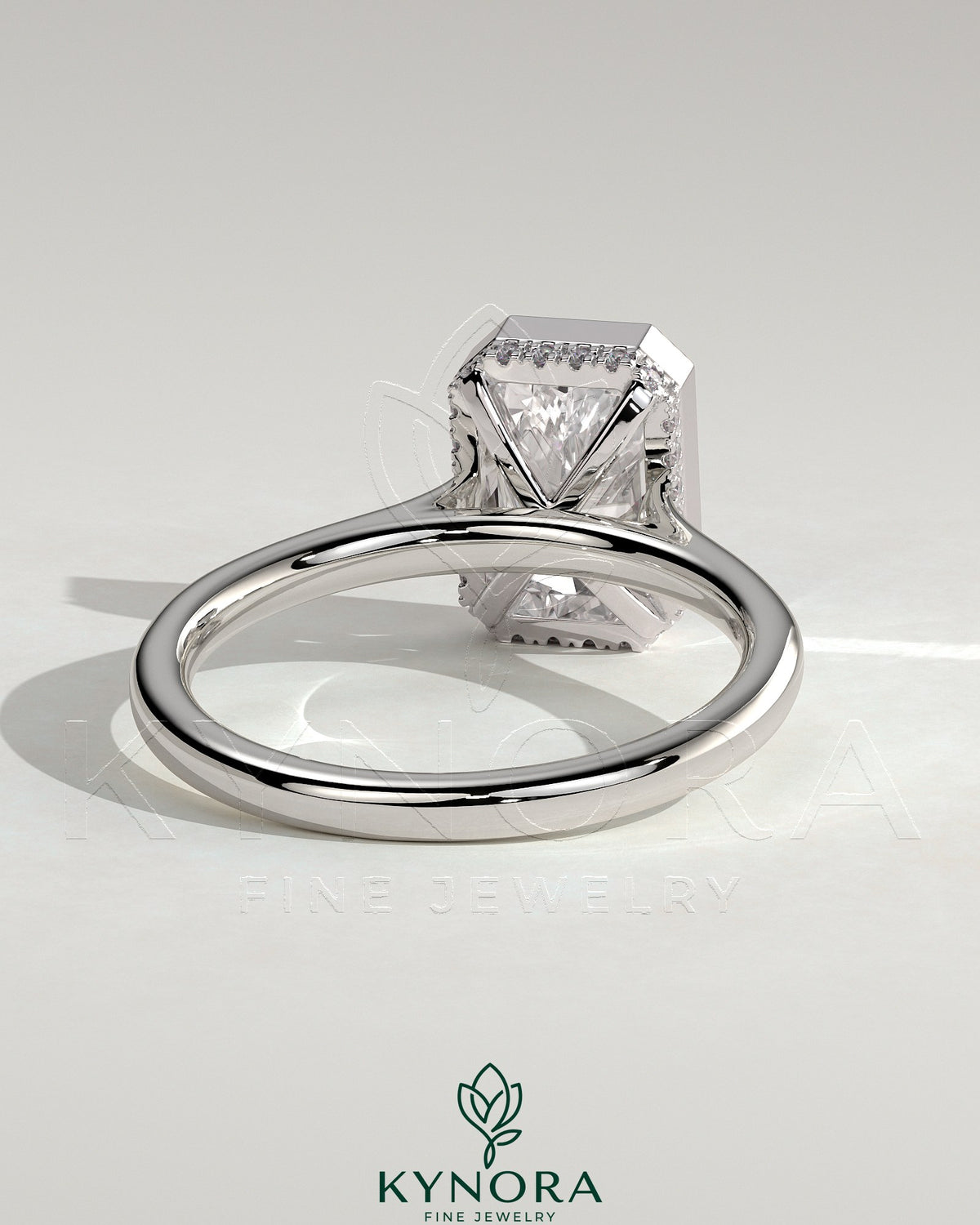 Kynora CJ 2ct radiant bezel solitaire engagement ring with hidden halo and cathedral high setting, showcasing sparkling diamond design.