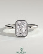 Kynora CJ 2ct radiant bezel solitaire engagement ring with petal gallery design, featuring a central diamond and intricate band details