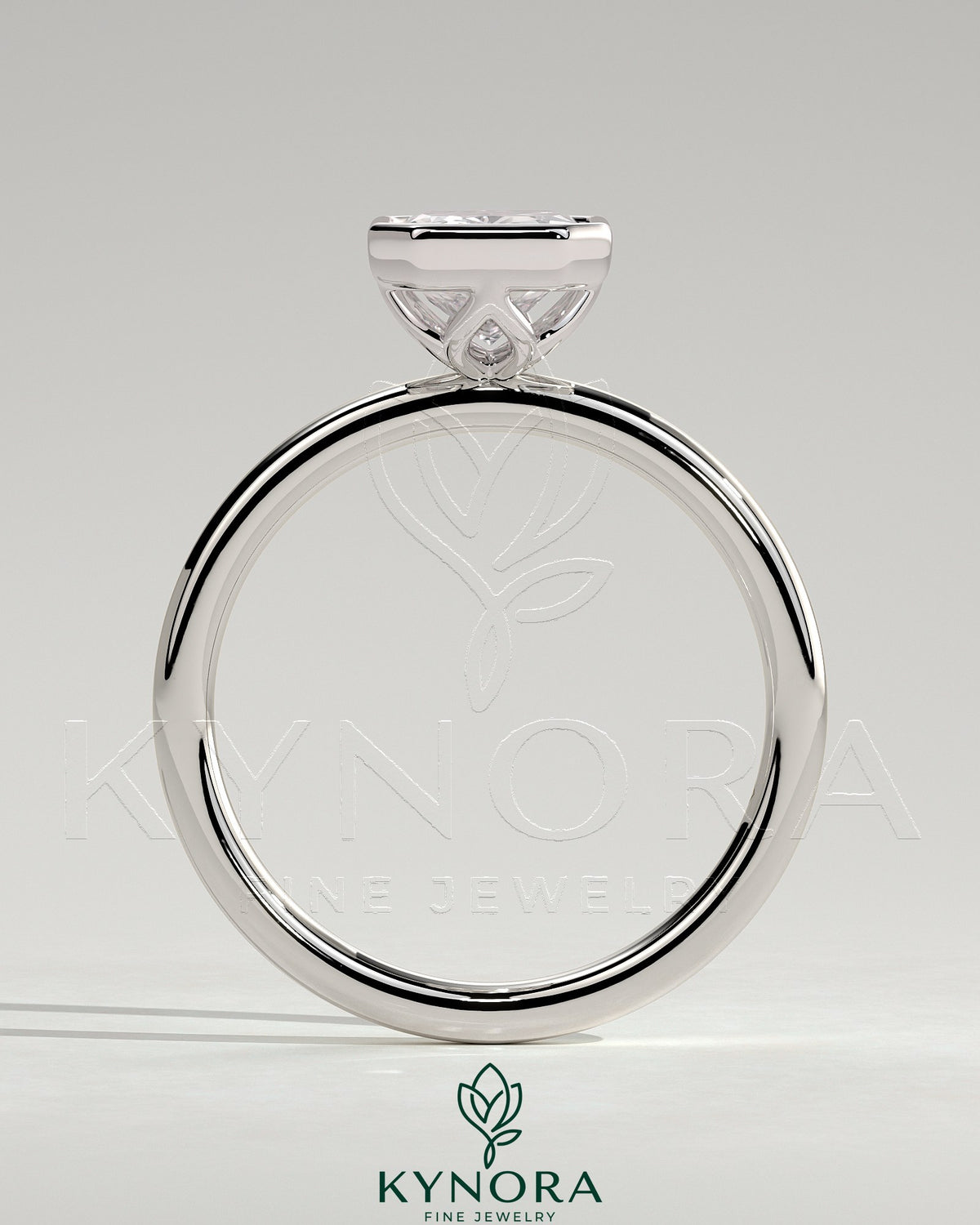 Kynora CJ 2ct radiant bezel solitaire engagement ring with petal gallery design, featuring a central diamond and intricate band detail.