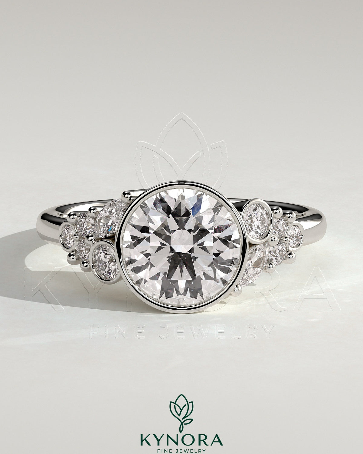 Kynora CJ 2ct round bezel solitaire engagement ring with clustered round and marquise shoulder stones in a detailed jewelry image. Main image