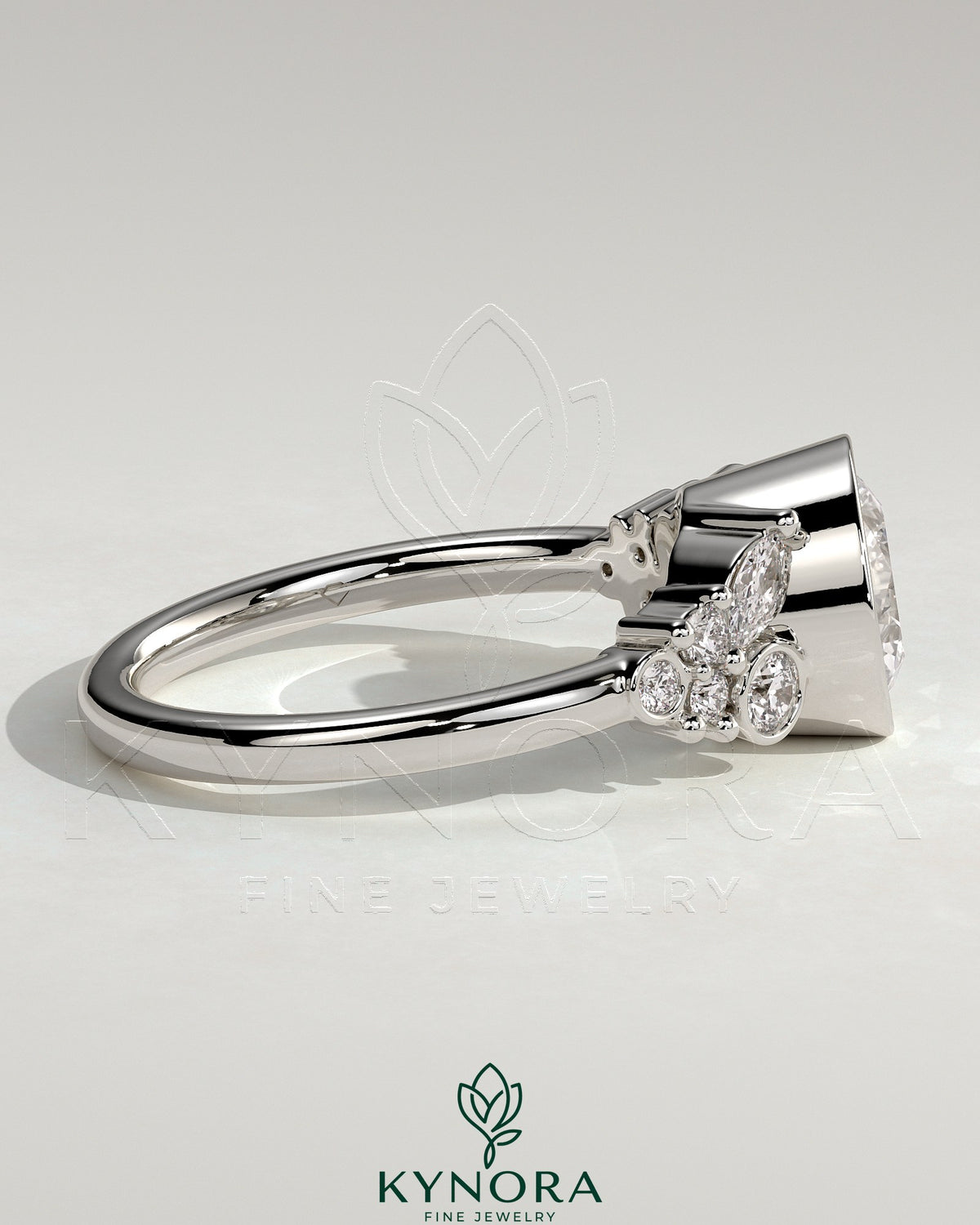 Kynora CJ 2ct bezel solitaire engagement ring with clustered round and marquise shoulder stones, elegant jewelry design
