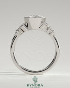 Kynora CJ 2ct round bezel solitaire engagement ring with clustered round and marquise shoulder stones in a sleek bezel setting