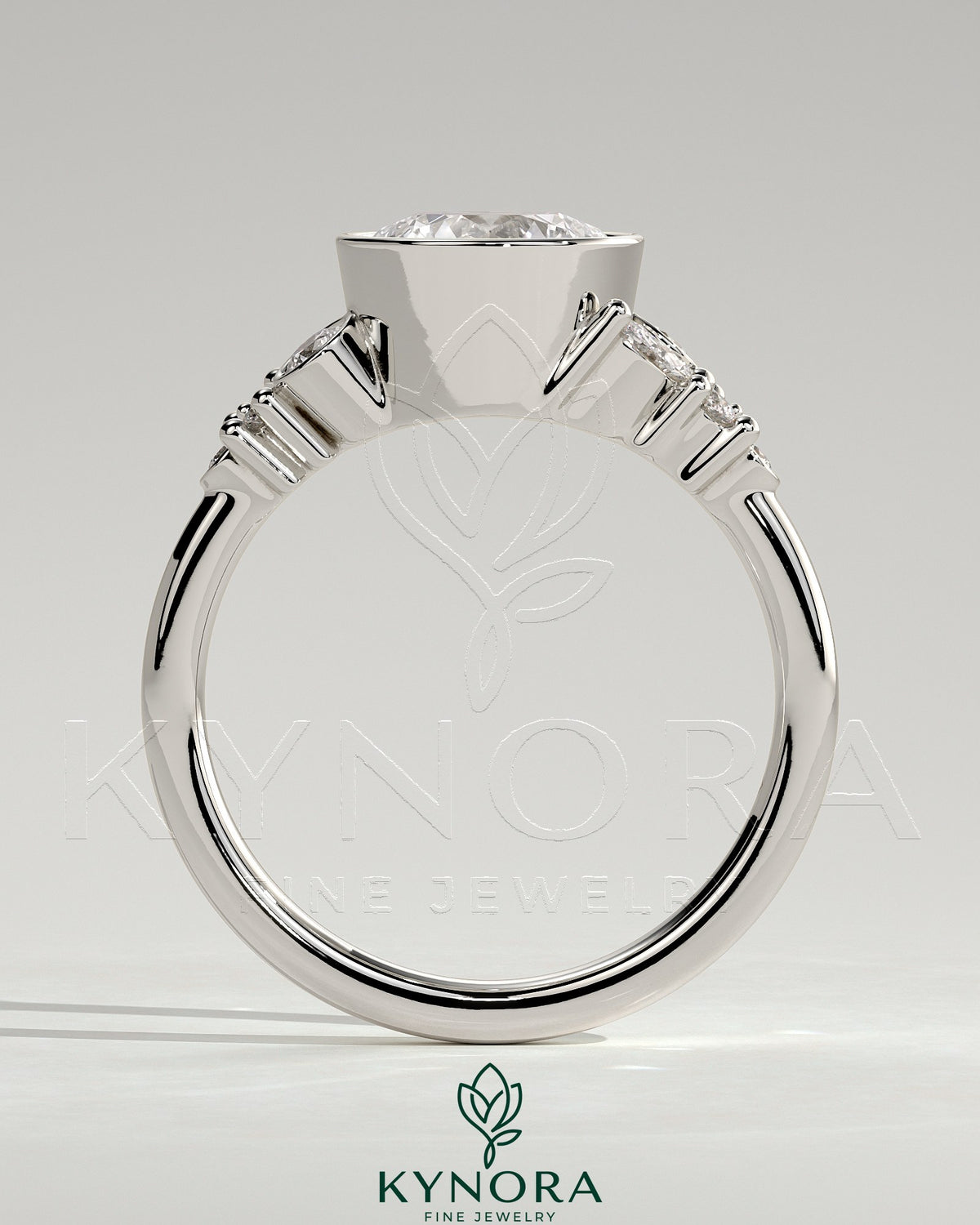 Kynora CJ 2ct round bezel solitaire engagement ring with clustered round and marquise shoulder stones in a sleek bezel setting