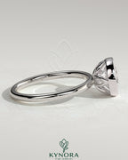 Kynora CJ 2ct round bezel solitaire engagement ring with petal gallery design in sleek gold setting.