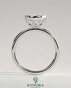 Kynora CJ 2ct round bezel solitaire engagement ring with petal gallery design, featuring a central diamond and intricate metalwork.