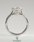 Kynora CJ 2ct round bezel solitaire engagement ring with twisted gallery design in a close-up view of the ring's intricate band and setting.